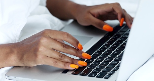 Close-up Of A Young Woman Using Laptop On Bed.