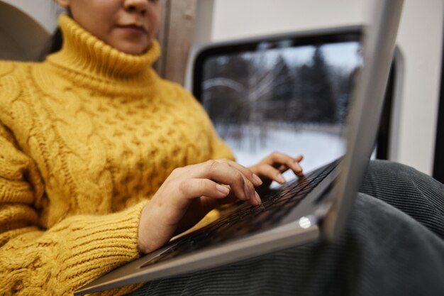 Close up of young woman using laptop in trailer van