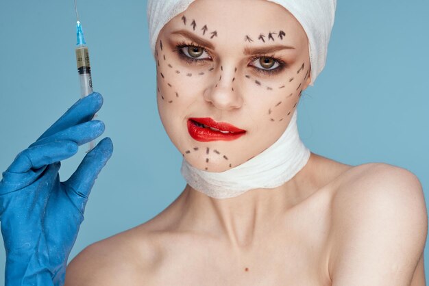 Close-up of young woman wearing mask against blue background