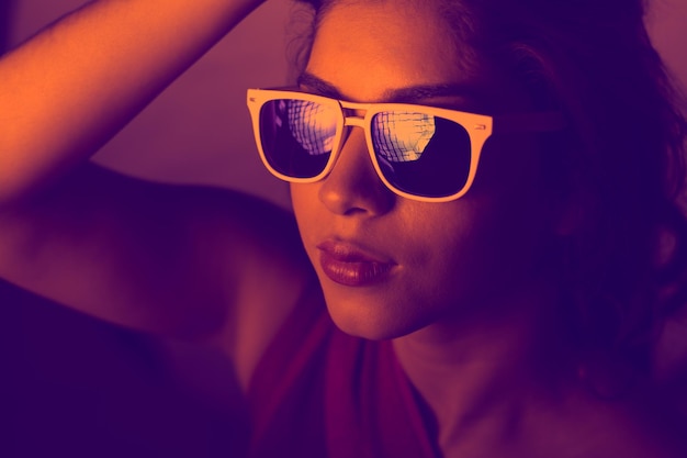 close-up of young woman wearing sunglasses outdoors