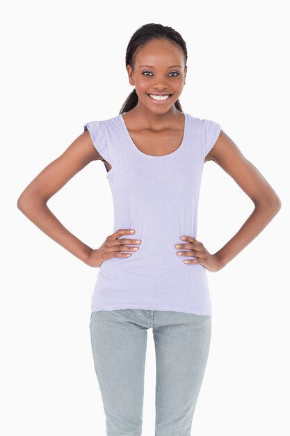 Close up of young woman with arms akimbo on white background
