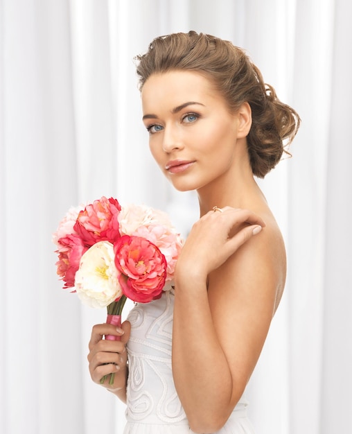 close up of young woman with bouquet of flowers