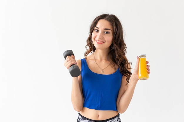 close up of young woman with a dumbbell in her hand