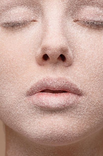 close-up of young woman with powder on face