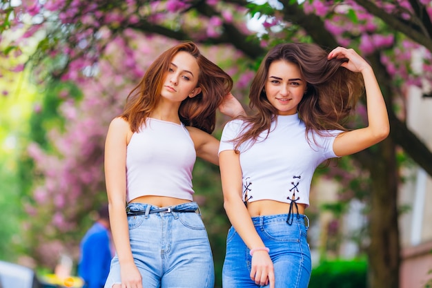 Close up of young women posing in the park outside