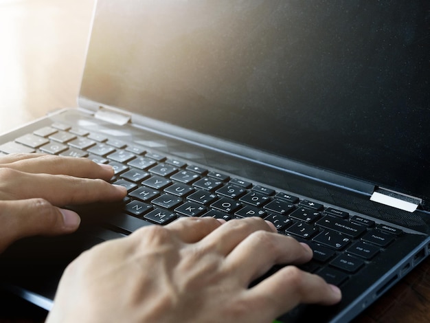 Close-up zakenman hand met behulp van laptop voor het werken aan de tafel