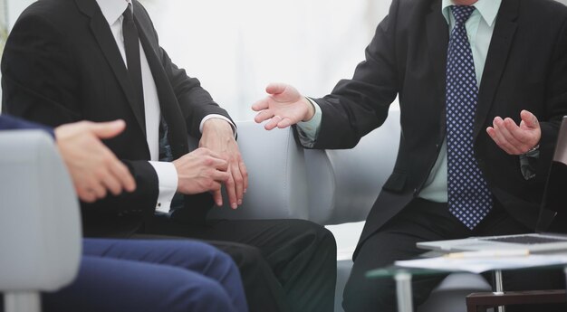 Close upa group of business people talking at a meeting