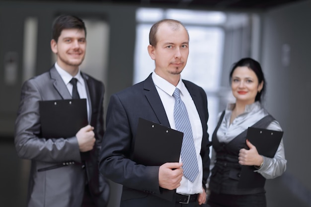 Close upa group of business people with clipboard