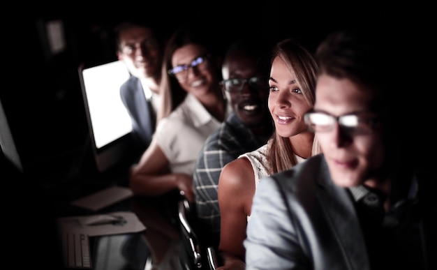 Close upa group of employees sitting in the computer room