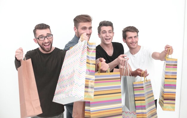 Close upa group of friends with shopping bags pointing at youthe concept of choice