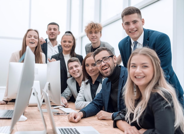 Close upa group of happy employees in the workplace