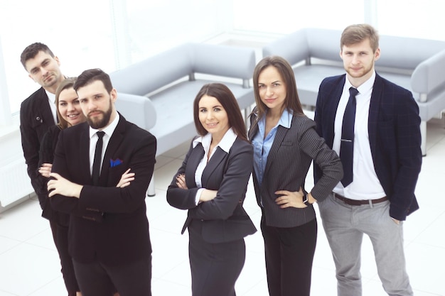 Close upa group of successful business people standing in the office hall