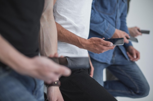 Close upa group of young people with smartphones