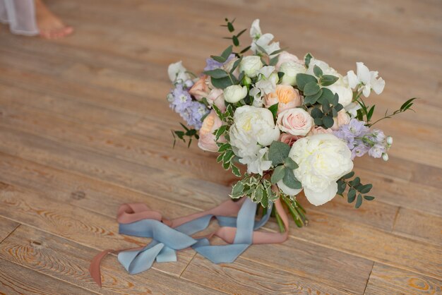 Close-upboeket van van de fresia'sdiesia van rozenpioenen dianthusbloemen binnen op ronde witte floore