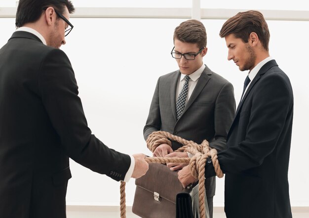 Close upbusiness colleagues are tied with a rope business metaphor