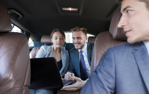 Close upbusiness colleagues discuss business issues sitting in the carbusiness trip