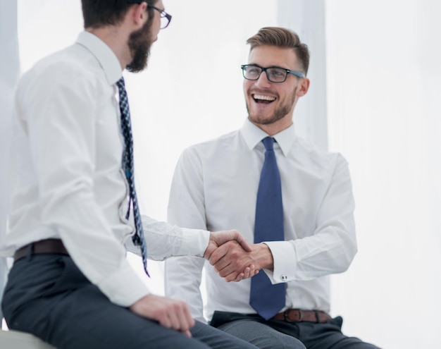 Close upbusiness handshake of business people on a light backgroundconcept of partnership