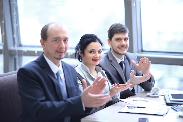 Close upbusiness team applauding the speakersitting in the workplace