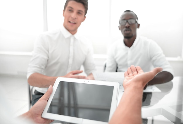 Close upbusiness team using a digital tablet in the office