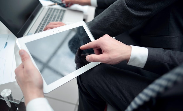 Close upbusinessman clicking on the digital tablet screen people and technology