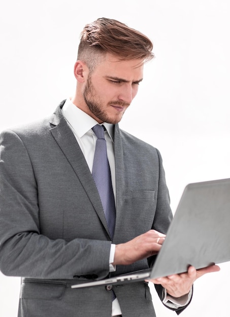 Close upbusinessman examines a new laptop