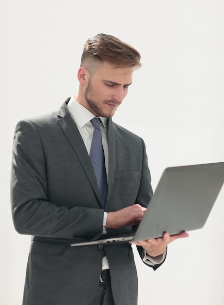 Close upbusinessman examines a new laptopisolated on white