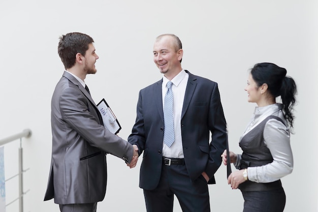 Close upbusinessman handshake with business woman concept of cooperation