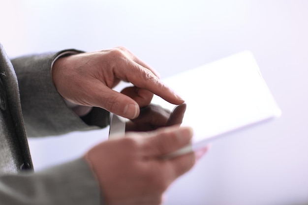 Close upbusinessman presses on the screen of a digital tabletp