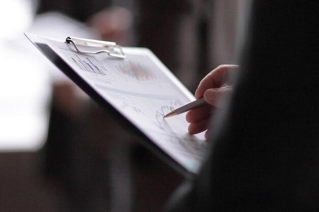 Close upbusinessman with a clipboard on the background of coll