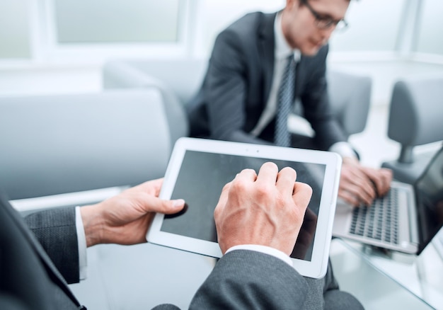 Close upbusinessman with a digital tablet in a modern office