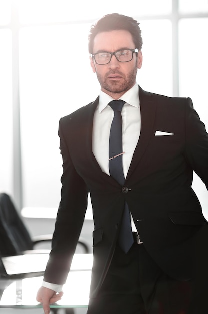 Close upconfident businessman standing in the office