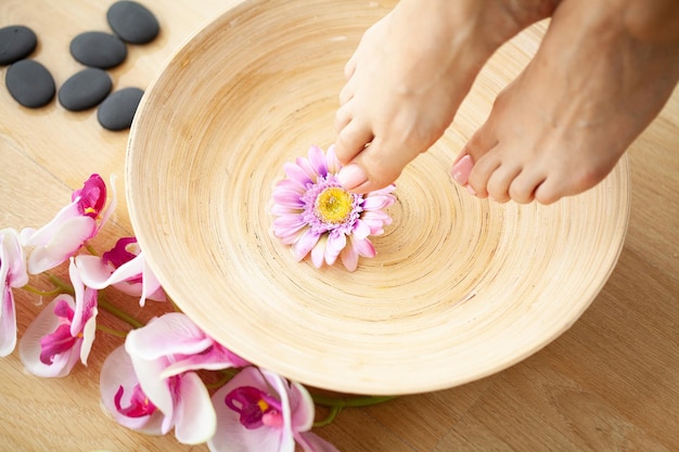 Foto close-upfoto van vrouwelijke voeten bij kuuroordsalon op pedicureprocedure