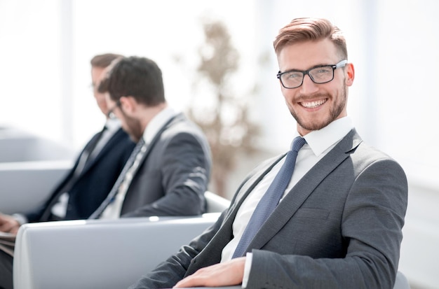 Close uphappy businessman sitting in modern officebusiness people