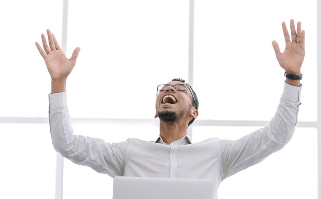 Close uphappy businessman sitting at the office Desk