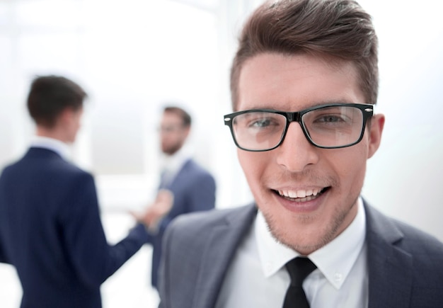 Close upmodern young businessman in the office background