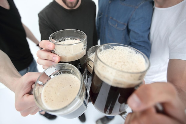 Close upmugs of beer in the hands of a group of menholiday concept