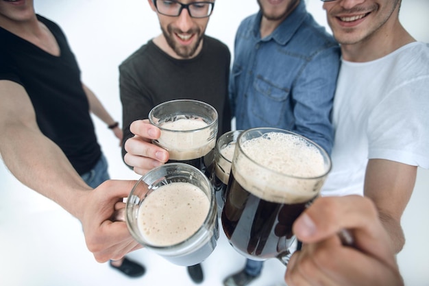 Close upmugs of beer in the hands of a group of menholiday concept