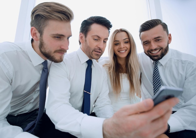 Close upsmiling staff discussing SMSpeople and technology