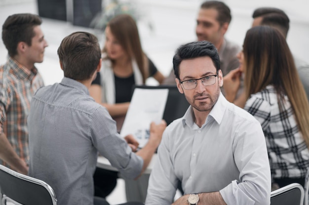 Close upsuccessful businessman against the background of the business teambusiness concept