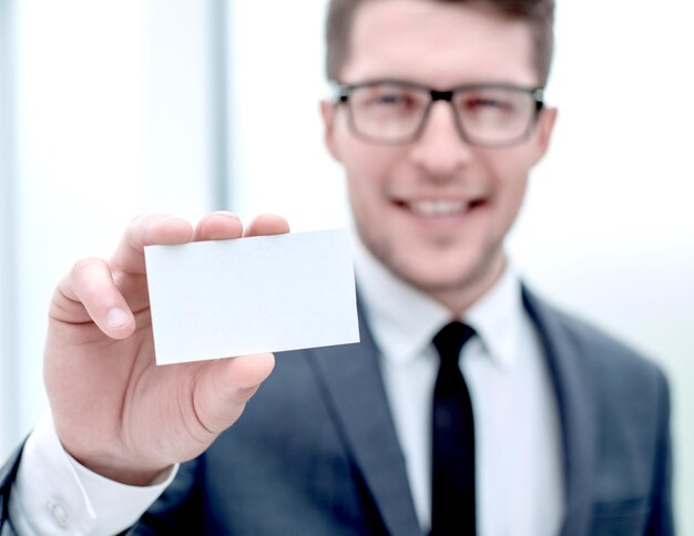 Close upsuccessful businessman showing his business card