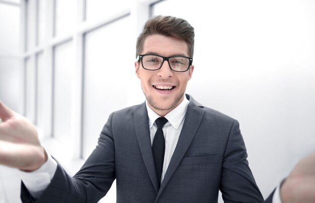 Close upsurprised young businessman standing near the window