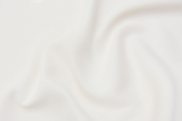 Close-uptextuur van natuurlijke beige of ivoren stof of doek in bruine kleur Stoffentextuur van natuurlijk katoen of linnen textiel Beige canvasachtergrond