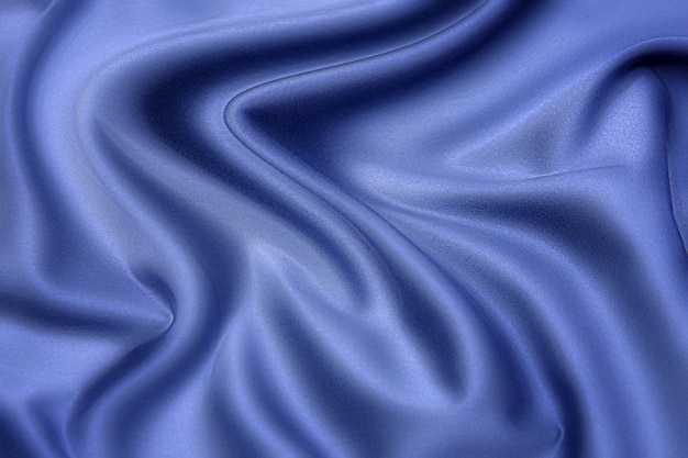 Close-uptextuur van natuurlijke blauwe stof of doek in dezelfde kleur. Stoffentextuur van natuurlijk katoen, zijde of wol, of linnen textielmateriaal. Blauwe canvasachtergrond.