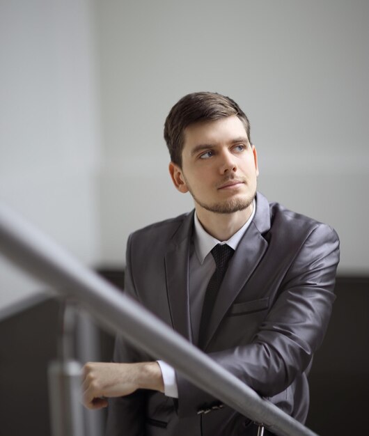 Close upthoughtful businessman looking out the office window