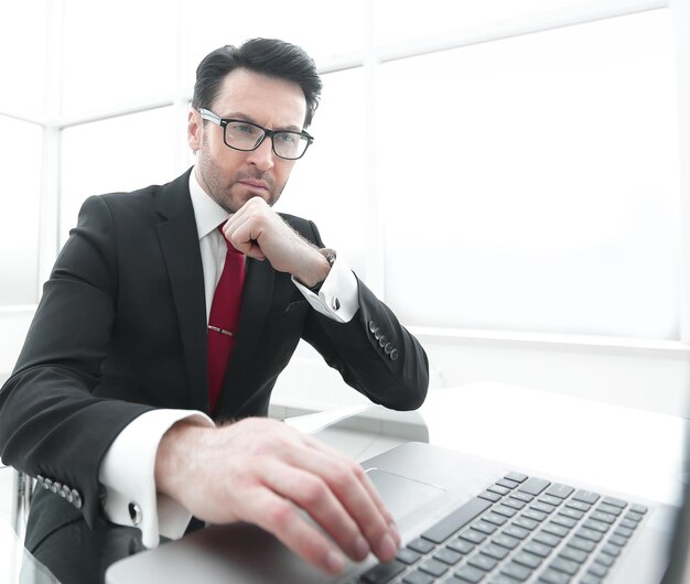 Close upthoughtful businessman working on a laptop