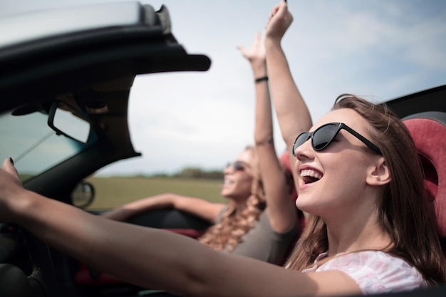 Close uptwo young women traveling in a car The freedom of the open road