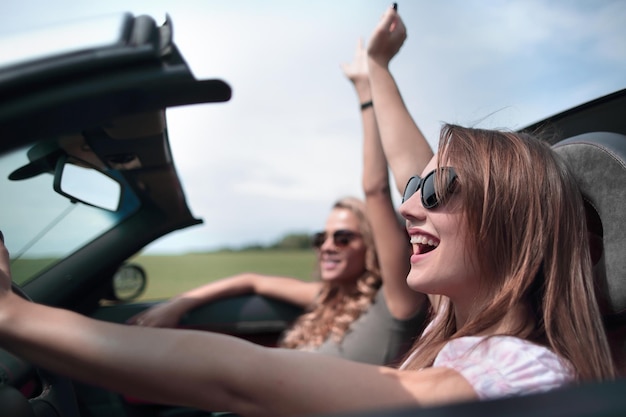 Close uptwo young women traveling in a car