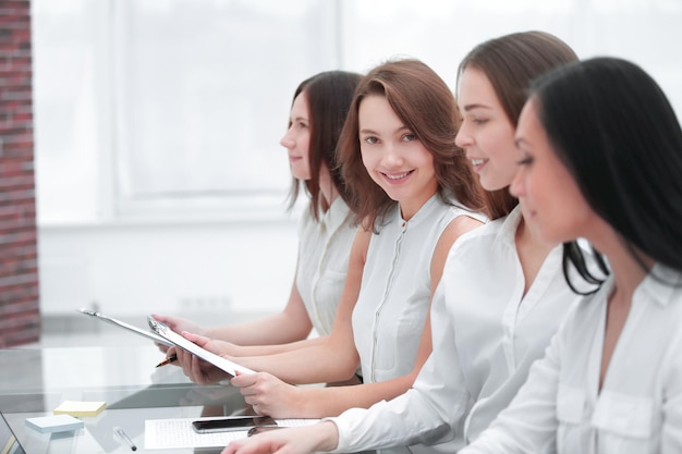 Close upyoung business woman on the background of colleagues