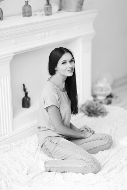 Close upyoung girl sitting on floor in living room