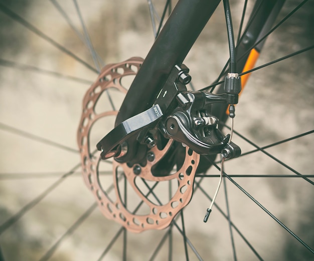 Close view of brake disk in good condition on the black bicycle